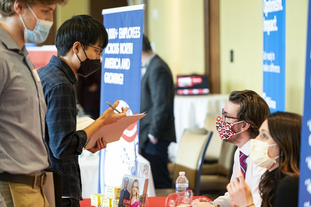 Representatives from Uline, a shipping and business supply company based in Pleasant Prairie, Wisconsin, talk with students.