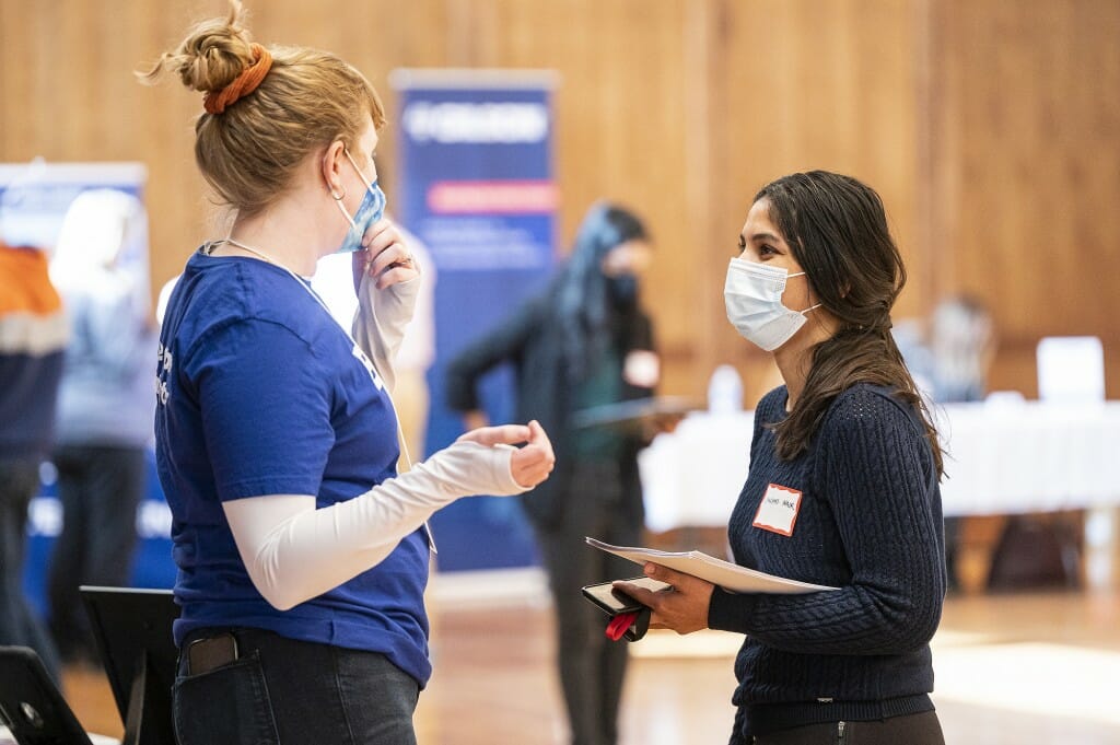 UW student Lakshmi Nair (right) speaks with Jocelyn Smith (left), a representative of Epic Systems, a Madison software company.