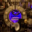 Photo: A mechanical chamber glows blue inside.