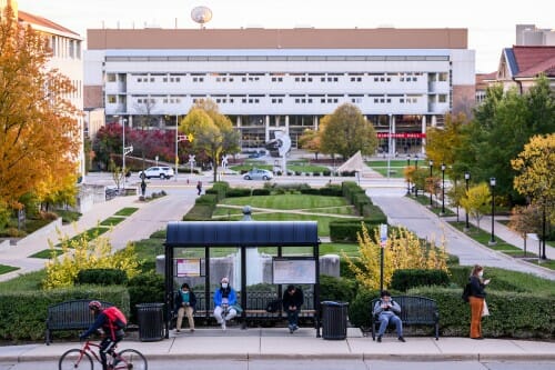 Photo: Engineering Hall is shown, along with a bicyclist going by.