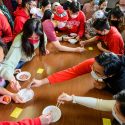 Photo: A group of students around a table.