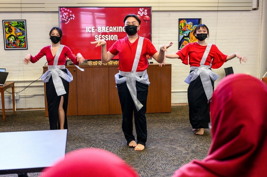 Photo: Several dancers and drummers line up.