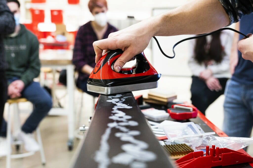 Then the wax is spread evenly across the skis.