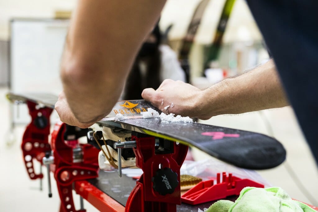 Photo: Someone applies wax to a ski.