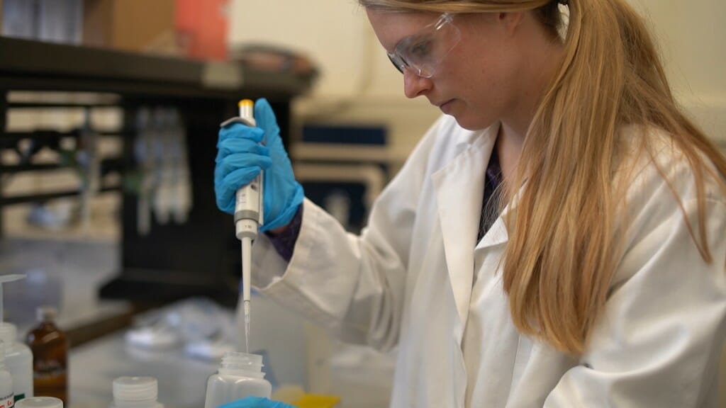 Balgooyen in a lab coat with a pipette