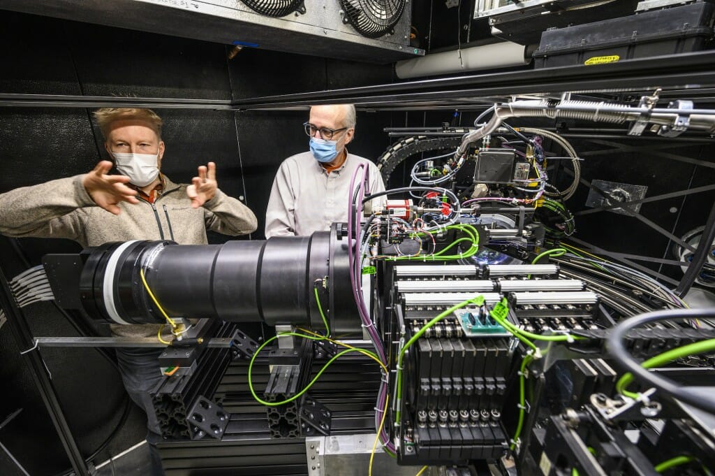 Smith and Percival standing behind spectrograph