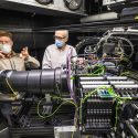 Smith and Percival standing behind spectrograph