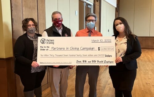 UW–Madison staff holding a large symbolic check representing $2 million of employee charitable giving