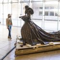 2 people looking at the statue in a glassy room at the Chazen