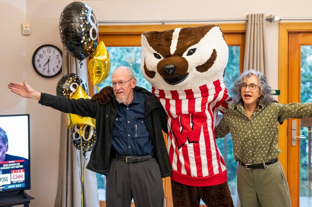 John, Bucky and Tess arm-in-arm and singing