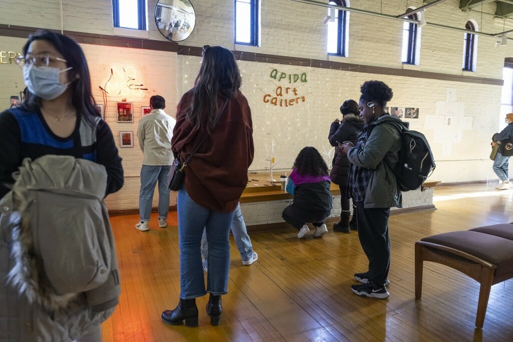 Guests peruse through student-created artwork.