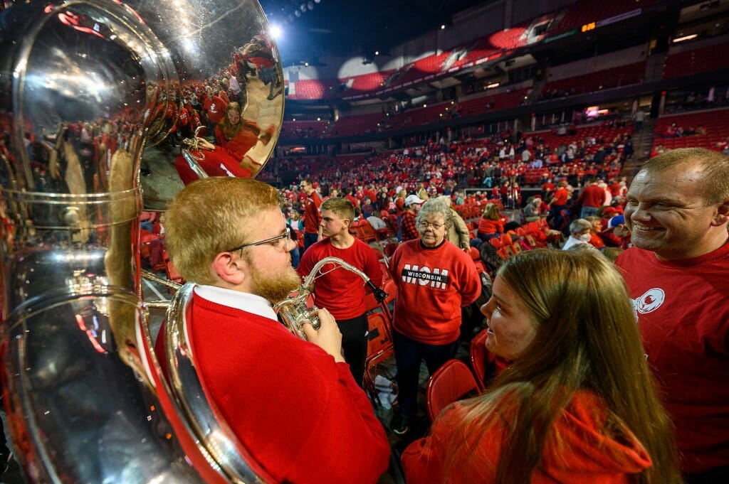 UW band member and sousaphone player Joseph Roethel is greeted by his family (clockwise from top brother, Benjamin Roethel; grandma, Corky Roethel; dad, David Roethel; and sister, Bethany Roethel) during the intermission of the concert.