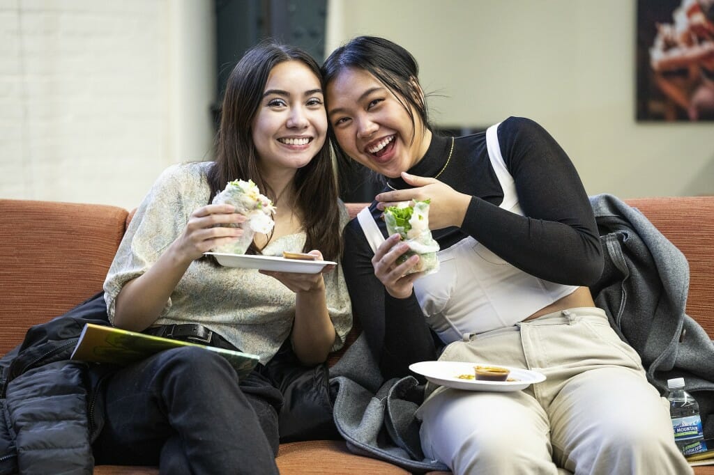 Samantha Greco (left) and Allie Ho enjoy spring rolls.