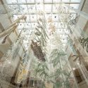 View from floor level looking up at skylights from which large embroidered plants are suspended