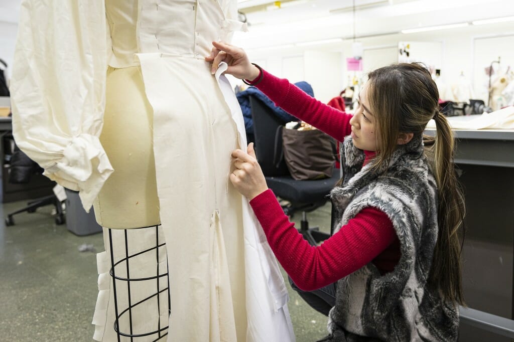 Noemie Nihei works on garment construction.