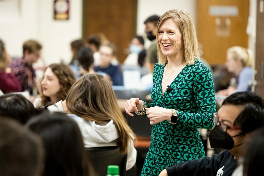 Stacy Forster standing in the midst of several students seated in a classroom