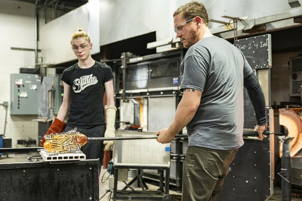 Ian Schmidt (right), 3D technician in the Art Department, holds a glass blowing demonstration.