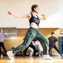 Students enthusiastically try out some steps during the hip-hop dance course.