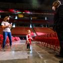 Ila greets UW band director Corey Pompey at the dress rehearsal of the UW Varsity Band Spring Concert in the Kohl Center.