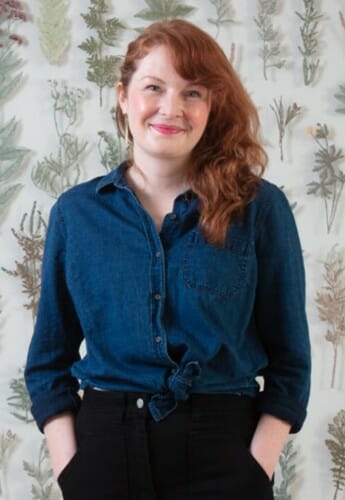 Portrait of Amanda McCavour in front of her installation, “Suspended Landscapes,”