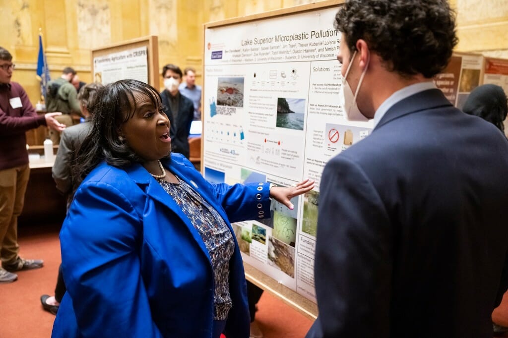 Rep. Stubbs facing Ben's poster while talking with him