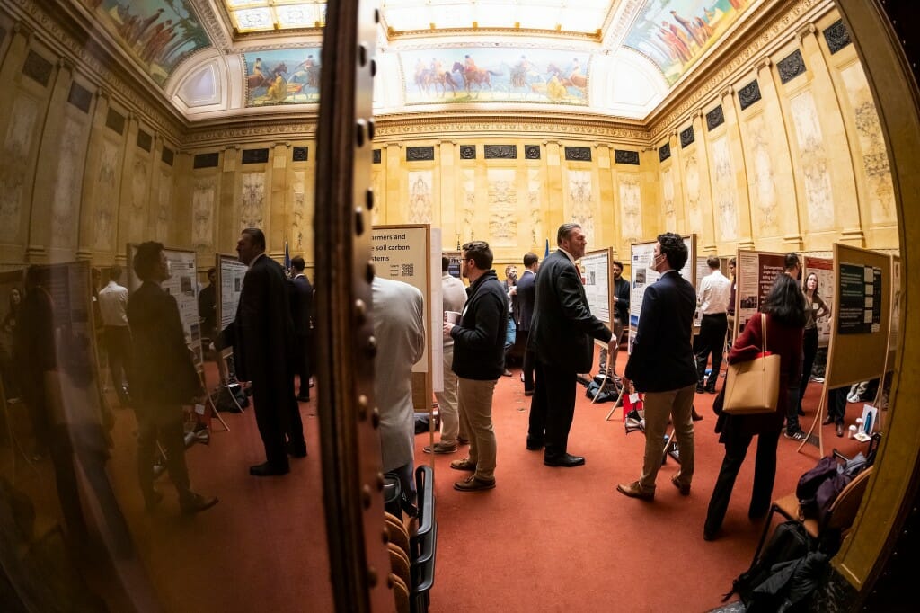 People standing inside hearing room