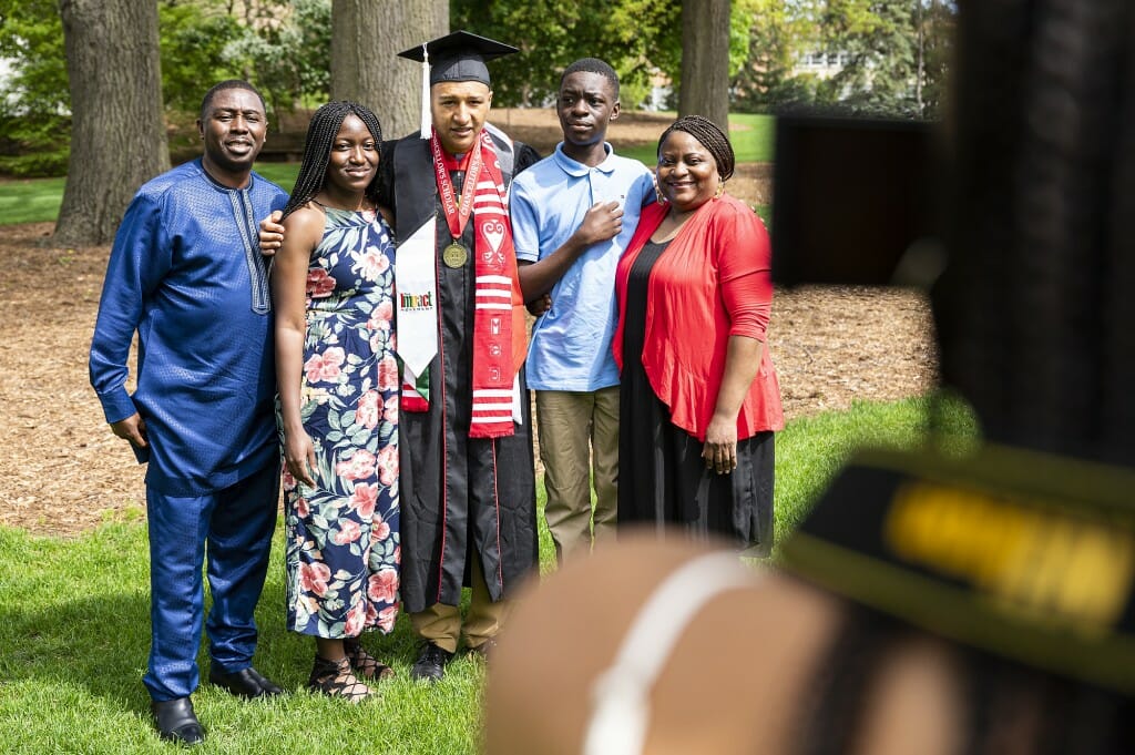 Several people standing in a group, posing for a photographer