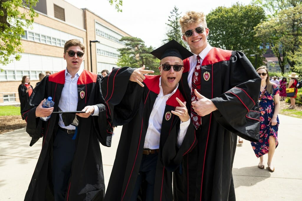 Three graduates mugging for the camera