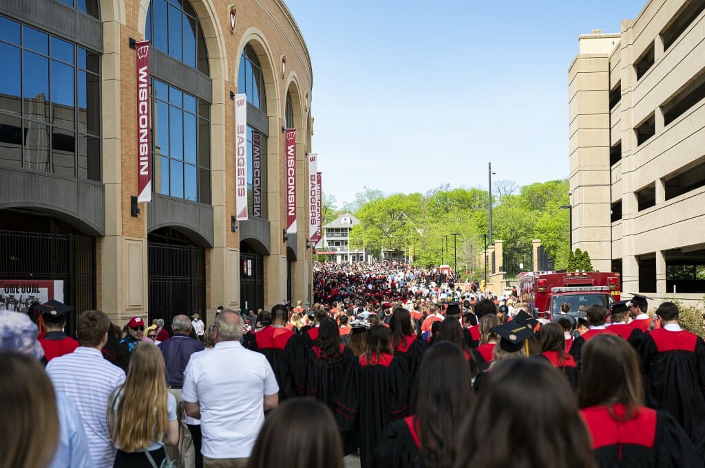 A crowd of people walking into the stadium entrances