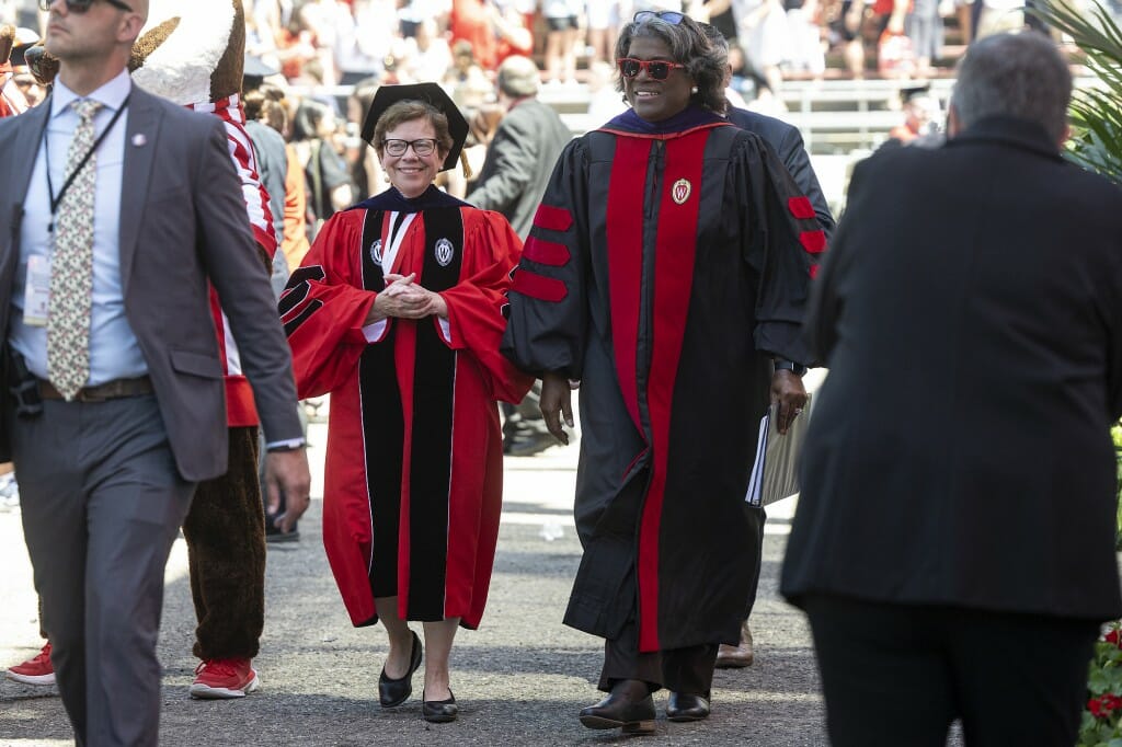 Rebecca Blank and Linda Thomas-Greenfield walking down an aisle in the stadium