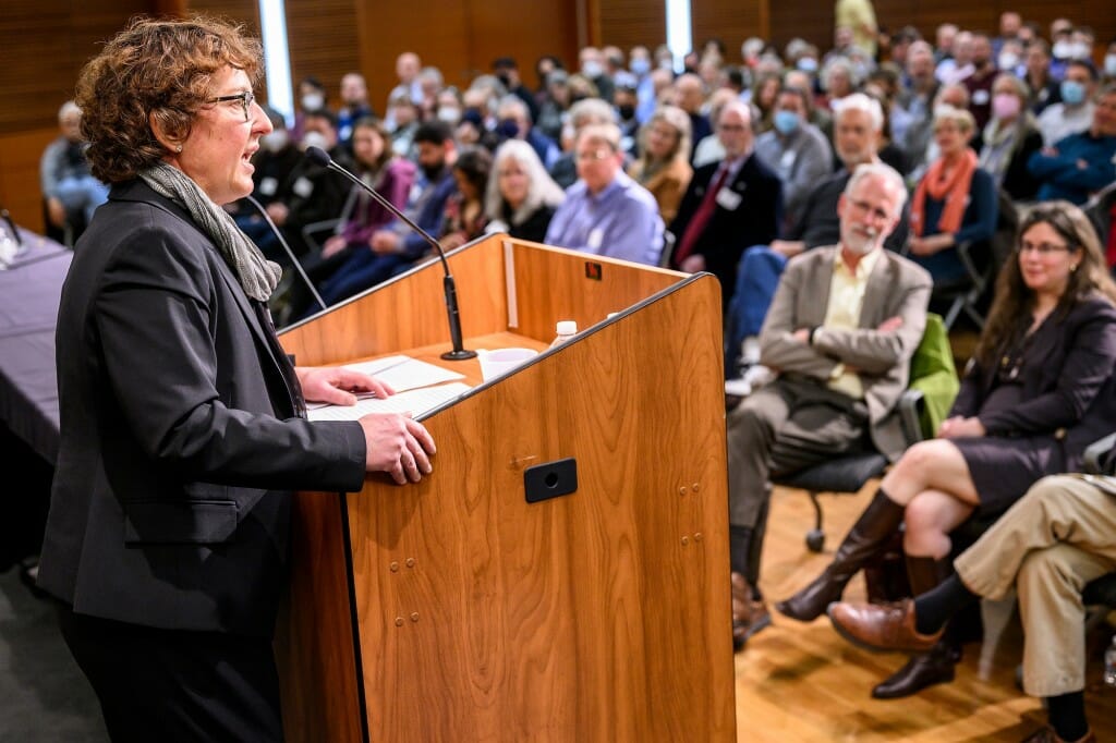 Zaeske speaking from a podium to a roomful of people