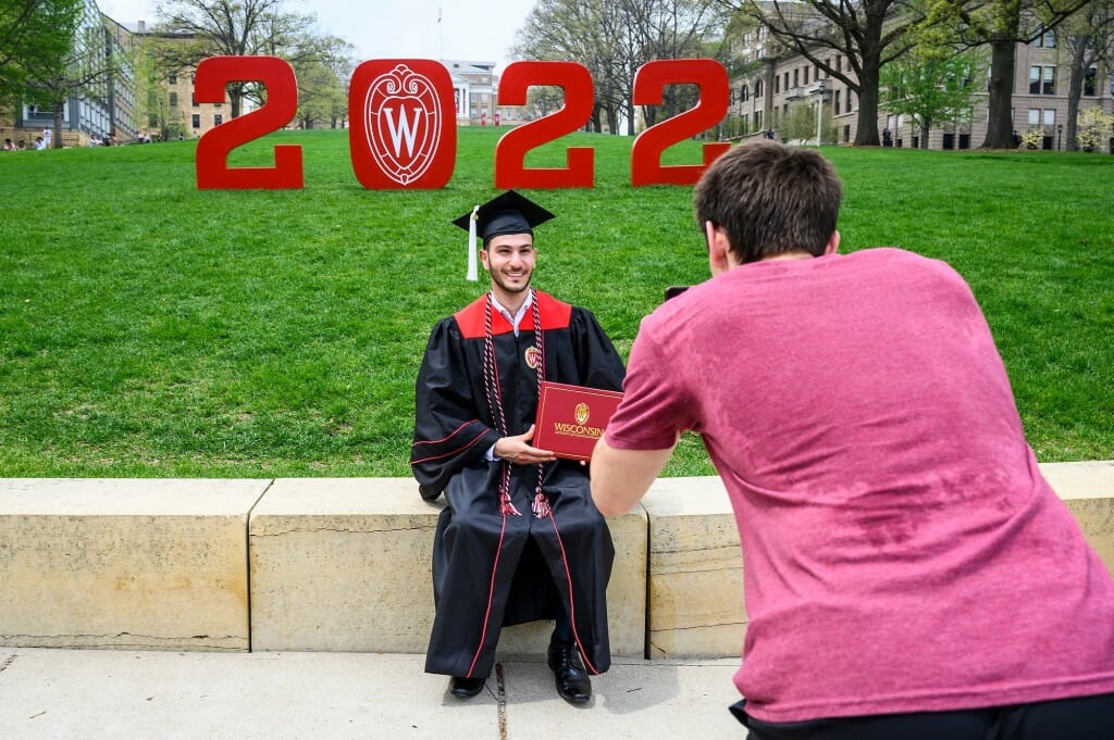 It’s a hot day!  Sophomore Michael Nichols takes a photo of poli sci graduate Canaan Odeh on Bascom Hill.