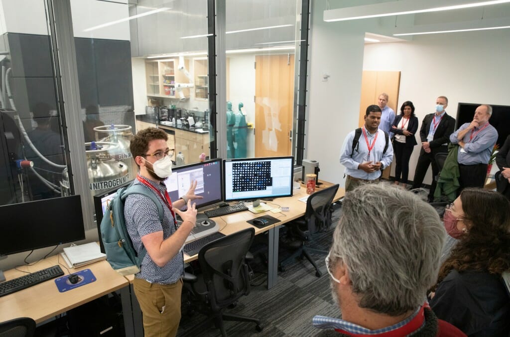 Thomas Anderson, a cellular and molecular biology graduate student working in the lab of biochemistry professor Robert Kirchdoerfer, and Anil Kumar, a research specialist in the cryo-EM centers, explain the inner workings of the Titan Krios cryo-electron microscope to their tour group at the Cryo-Electron Microscopy Research Center. 