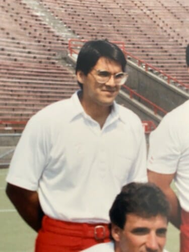 Mick as a graduate student wearing a football coach's uniform