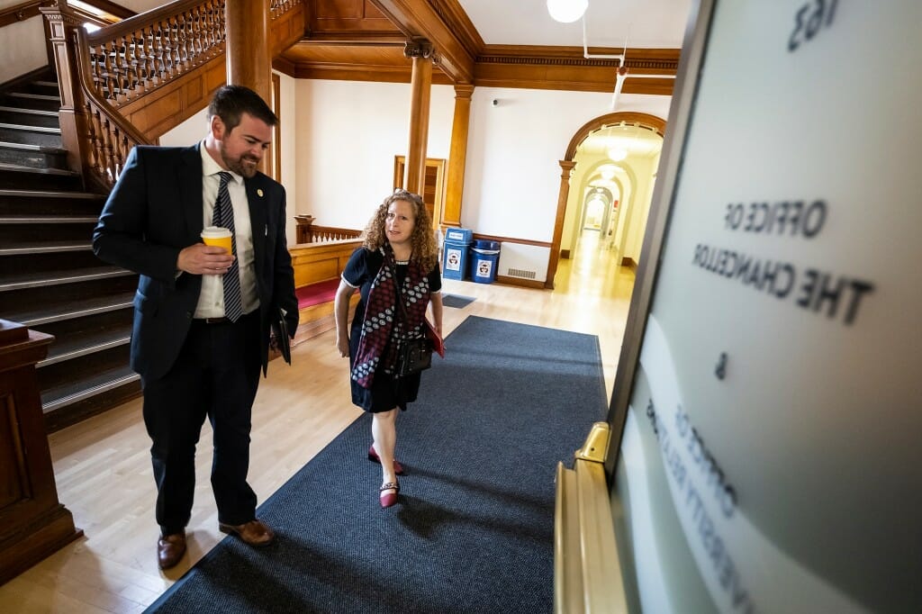 Mayrl and Mnookin approaching open door to chancellor's office