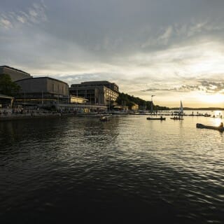 A sun sets over Lake Mendota, its light reflected on the water.