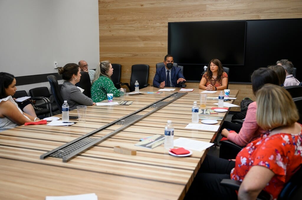 At center left from left to right, Aaron Bird Bear, director of tribal relations, and Rachel Byington, Tribal Youth and Community Liaison (for Earth Partnership, within the Department of Planning and Landscape Architecture) speak to staff members.