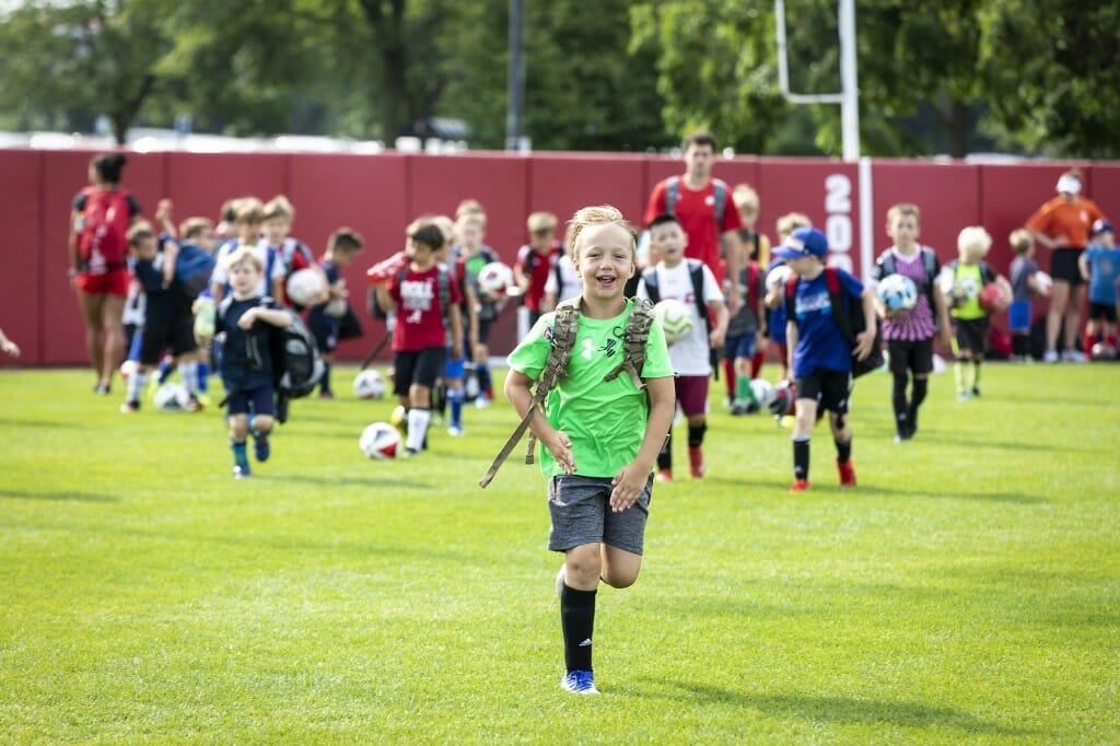 Everyone's excited to arrive at boys' soccer day camp.