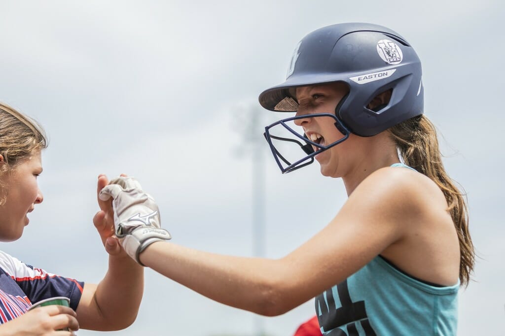 Kids at a softball day camp showed plenty of team spirit.