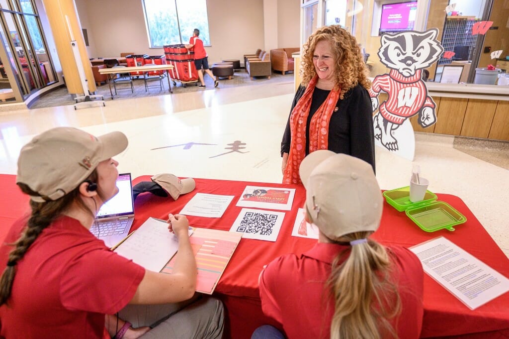 Chancellor Mnookin talks with two people at a desk.