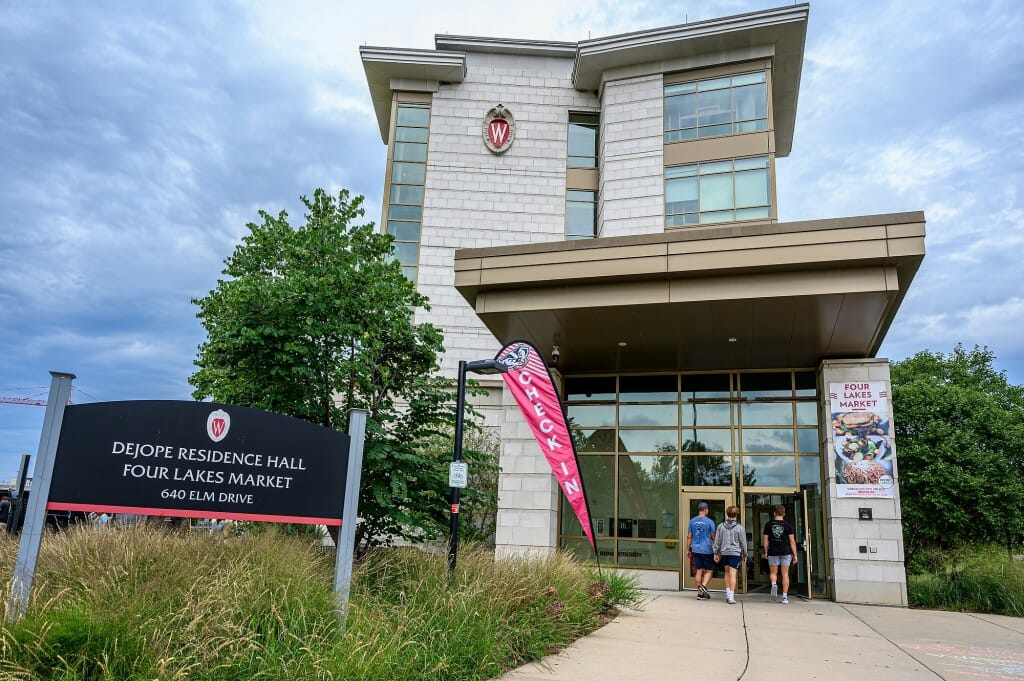 People walk through the doors during move-in day at Dejope Residence Hall.