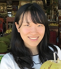 smiling woman with long, dark hair