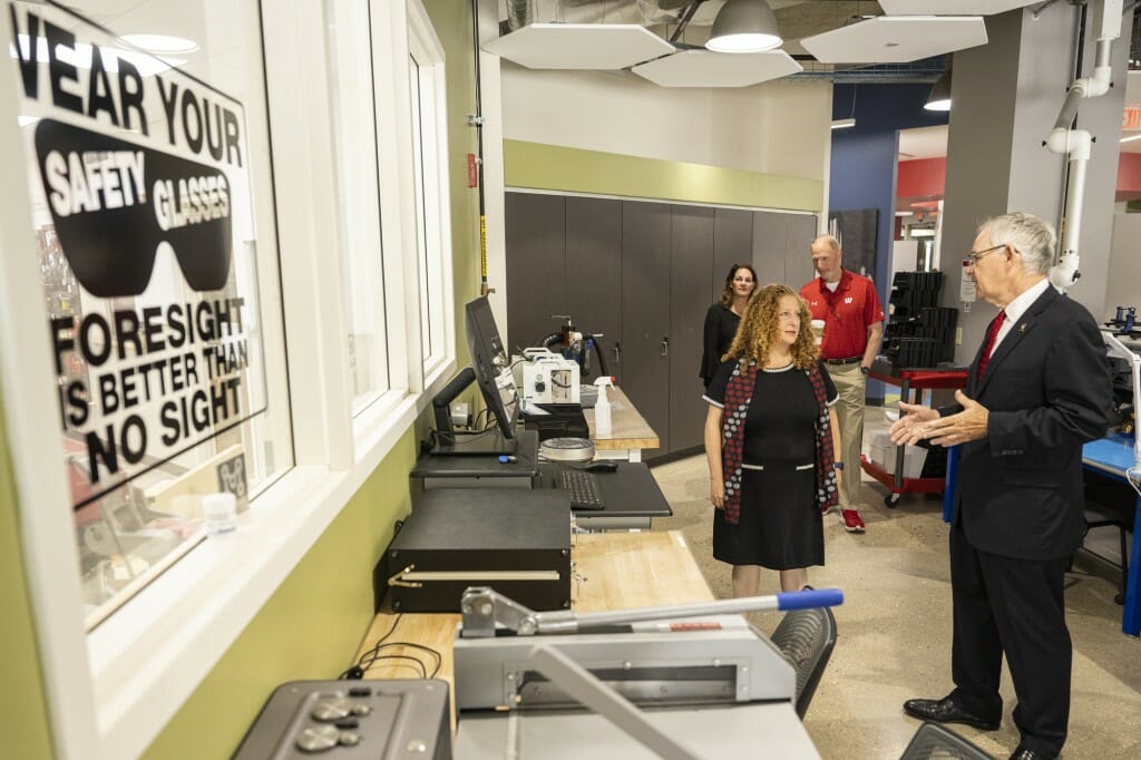 Jennifer Mnookin speaks with Ian Robertson as they stand in the Makerspace room.