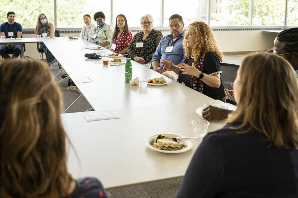 Chancellor Mnookin sits at a table and speaks with UW-Madison faculty