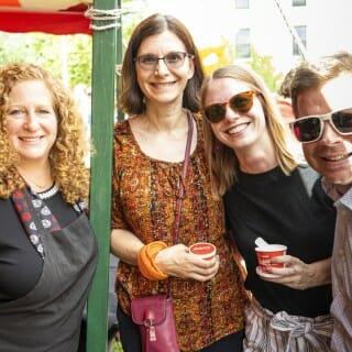 Four people pose for a photo.