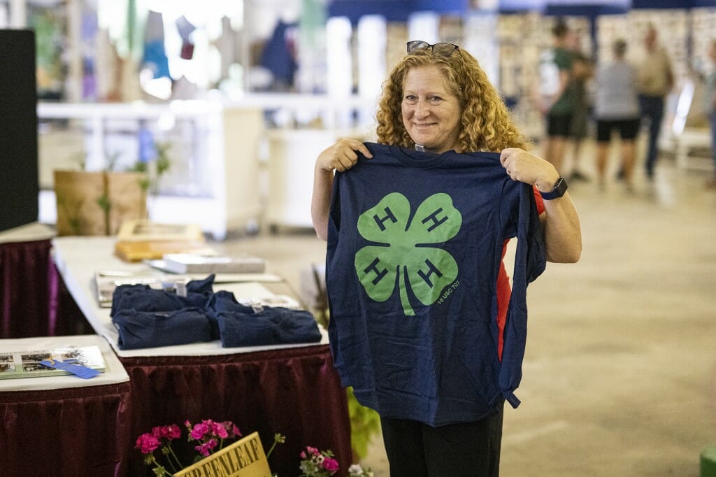 Chancellor Mnookin tries out a 4-H Club shirt.