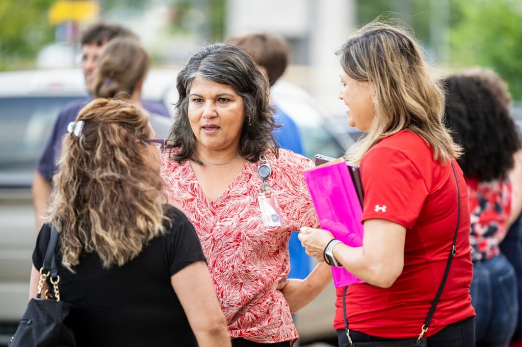 Brenda Gonzalez, director of community relations for UW–Madison, talks with attendees during a community celebration event.