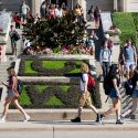 Students walk various directions on a staircase.