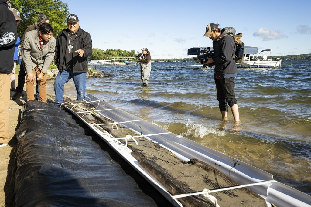 Casey Brown (left), spokesperson for the Ho-Chunk Nation and member of the Bear clan, and Bill Quackenbush, tribal historic preservation officer for the Ho-Chunk Nation and member of the Deer clan, take a closer look during the recovery of a 3,000-year-old dugout canoe.