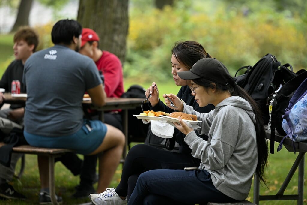 Students enjoy grilled food together